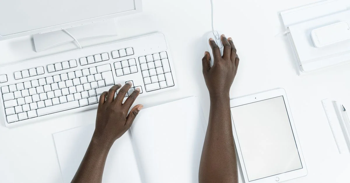 Configuration de bureau minimaliste avec clavier, souris et tablette vues de dessus.